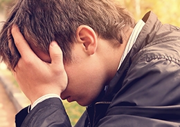 man holding head in hands