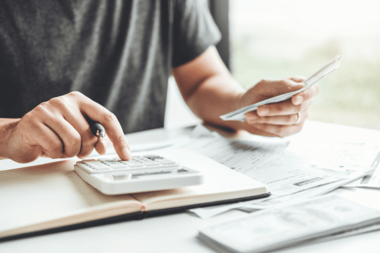 man checking finances using calculator