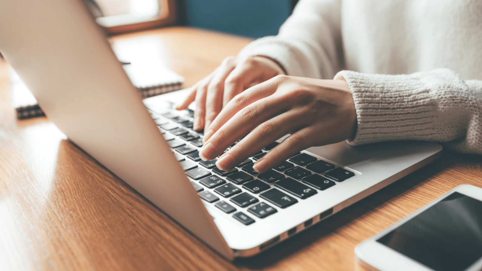 woman typing on laptop