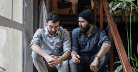 Two men sitting on the stairs.