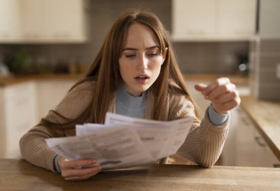 Woman worried looking at bills